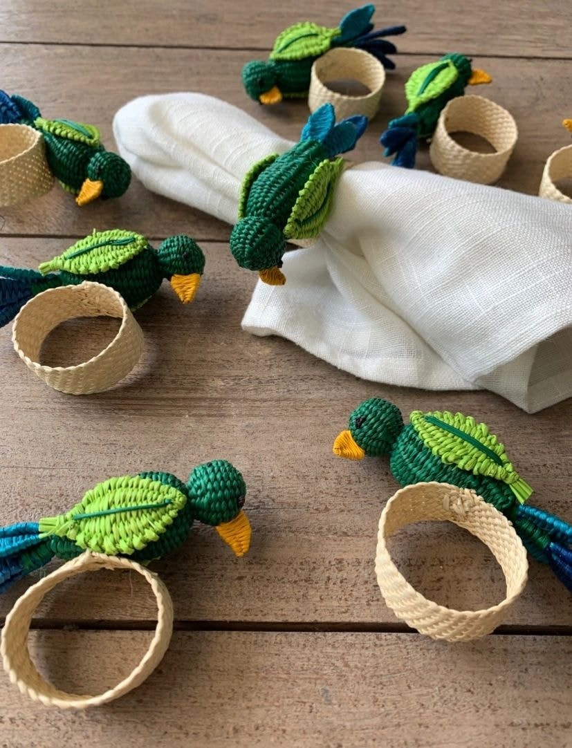 Handmade crochet napkin rings and woven baskets on wooden table
